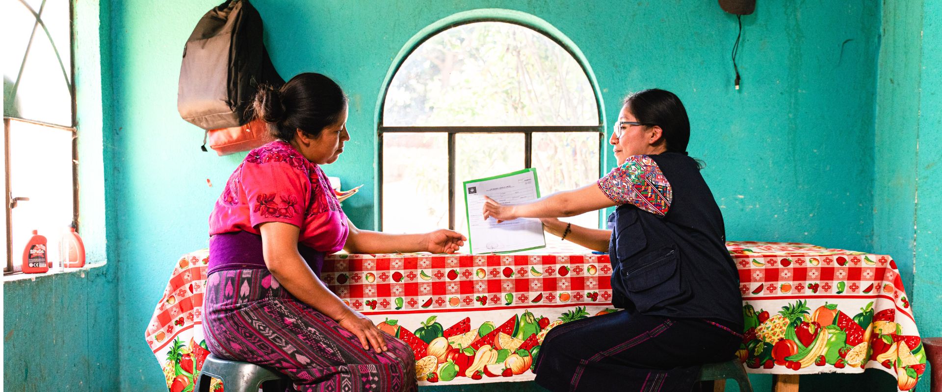 Women's Health program manager speaking with a patient during a home visit